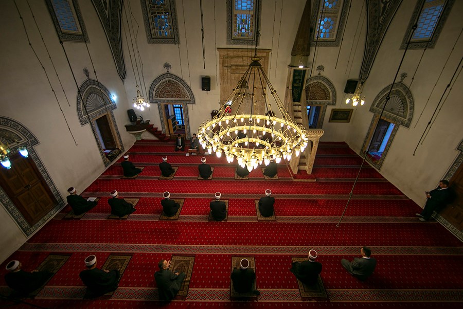 Imams keeping physical distance at the grand mosque in Pristina, Kosovo, during Eid prayers.