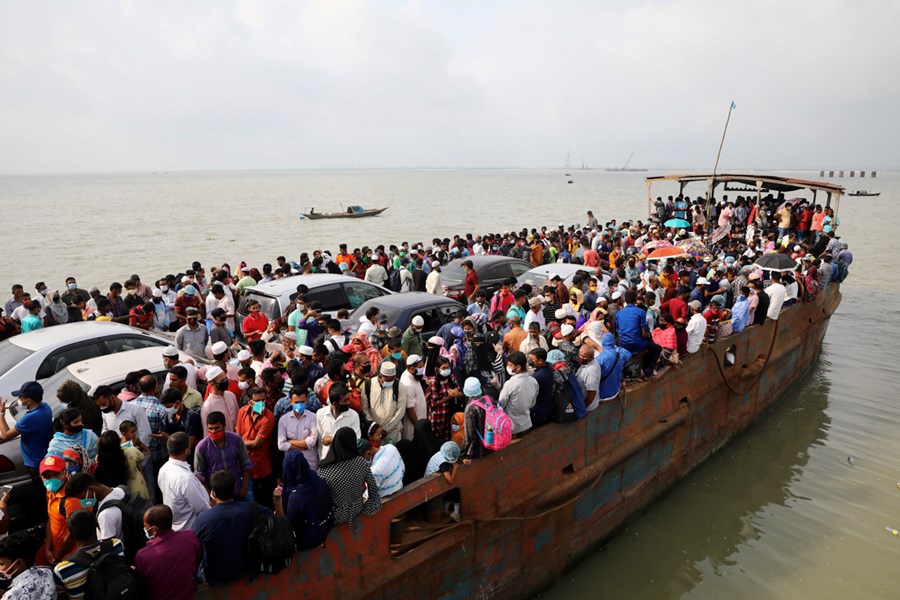 Migrant people are seen on board of an overcrowded ferry, as they go home to celebrate Eid al-Fitr amid concerns over the coronavirus disease (COVID-19) outbreak, in Munshiganj