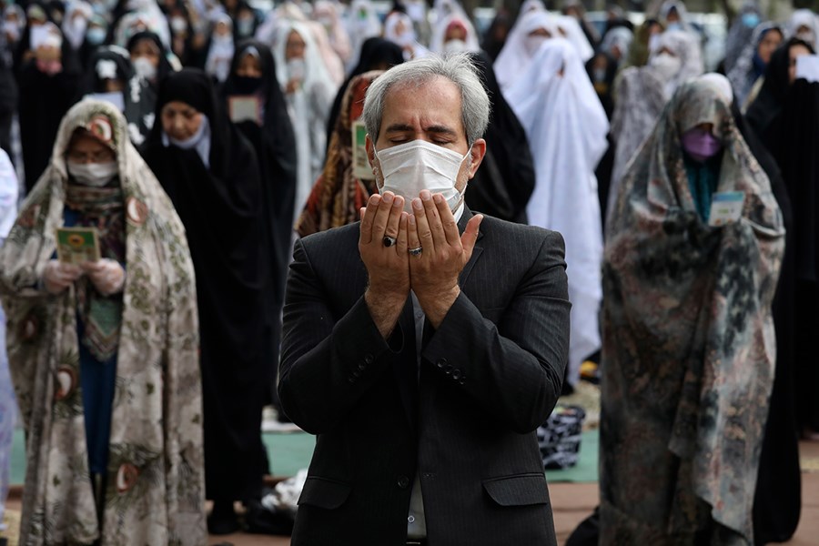 Worshipers wearing protective face masks offer Eid prayers outside a mosque in Tehran, Iran.